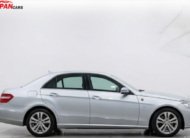 Mercedes-Benz E300 2012 silver luxury sedan with 3.0L engine parked on road