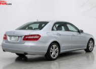 Mercedes-Benz E300 2012 silver luxury sedan with 3.0L engine parked on road