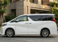 2023 Toyota Alphard luxury minivan in white parked in modern city