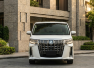 2023 Toyota Alphard luxury minivan in white parked in modern city