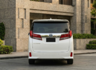 2023 Toyota Alphard luxury minivan in white parked in modern city