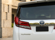 2023 Toyota Alphard luxury minivan in white parked in modern city