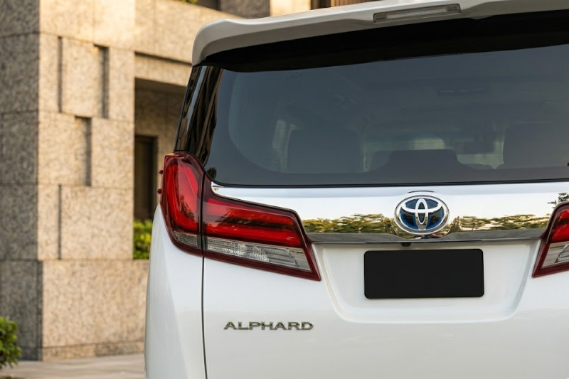 2023 Toyota Alphard luxury minivan in white parked in modern city